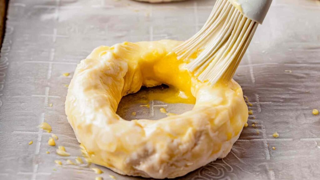Brushing Egg Wash on Cottage Cheese Bagel Dough

