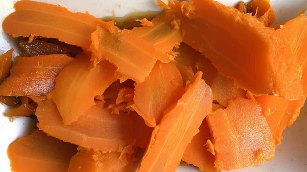 Roasted carrot slices freshly peeled and ready to be marinated for vegan lox preparation.