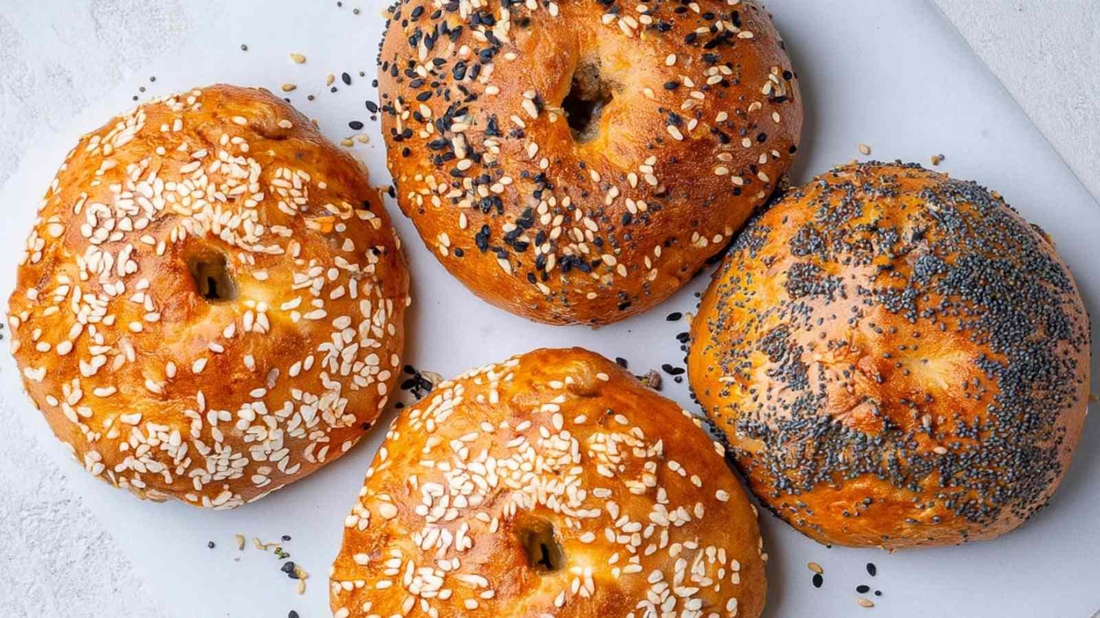 Assorted cottage cheese bagels with various toppings arranged on a marble board, golden and crispy from air frying.