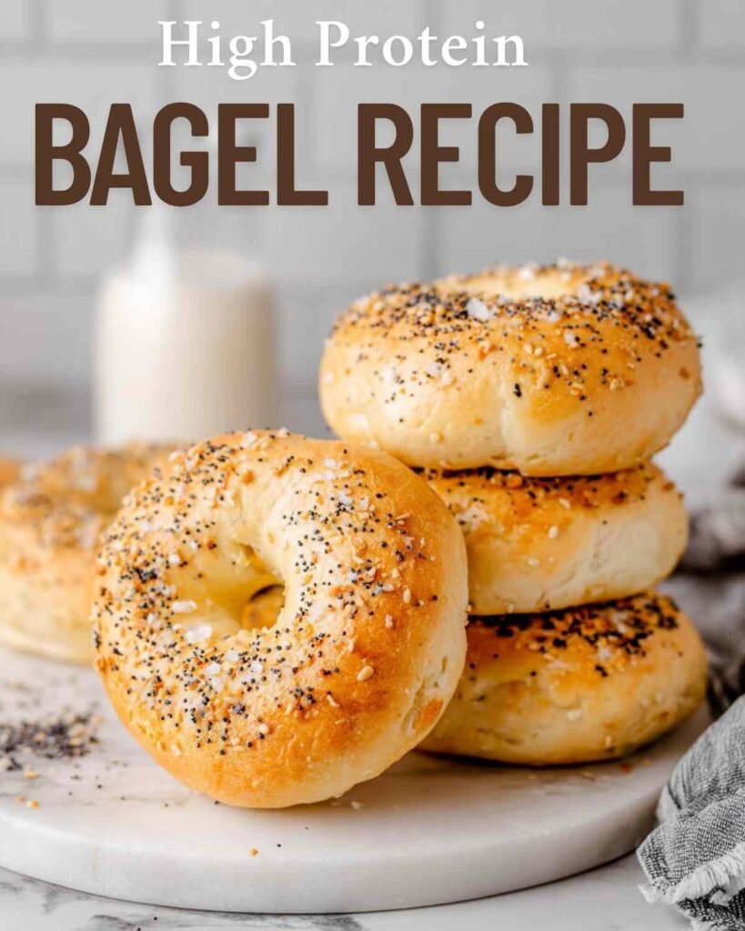 Hero shot of stacked bagels with “High Protein Bagel Recipe” text overlay on a bright kitchen background.

