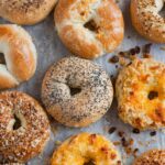 Top-down view of a variety of freshly baked bagels, golden brown and crispy