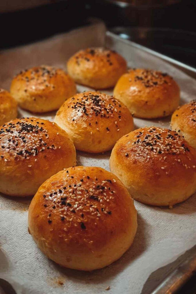 Close-up of a halved stuffed bagel mini revealing gooey cream cheese filling and tender baked dough