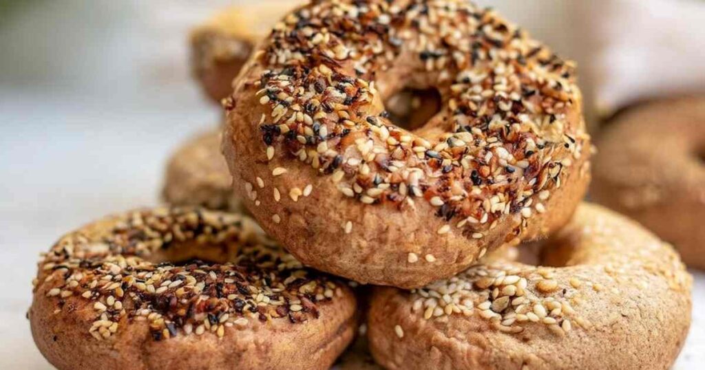 Close-up of a Thomas' high protein bagel with everything seasoning, showing toasted sesame and chia seeds on a golden crust