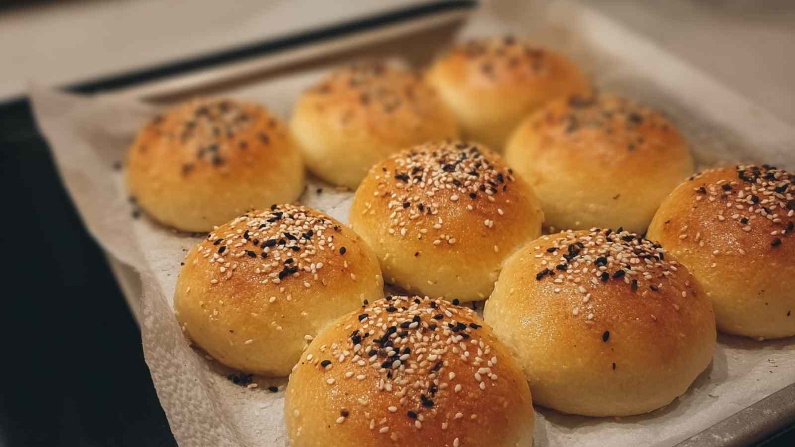Tray of golden-brown Dunkin stuffed bagel minis fresh out of the oven, topped with everything bagel seasoning