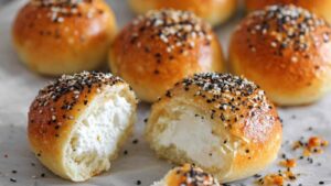 Close-up of stuffed everything bagel bites with cream cheese filling oozing out from the center