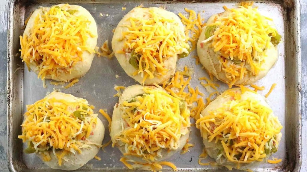 Unbaked Cheese Topped Chile Bagels