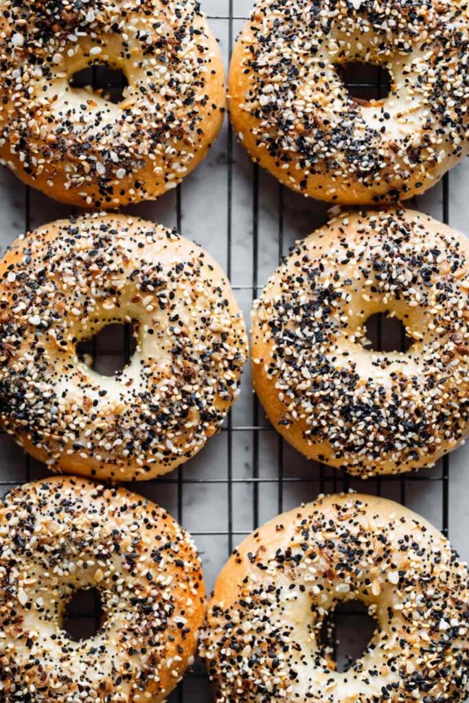 Baked Onion Bagels With Seeds On Rack