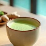 Close-up of a finished Japanese Mounjaro drink in a ceramic cup with ginger in background.