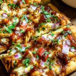 BBQ Chicken Flatbread with melted cheese and bell peppers on baking sheet