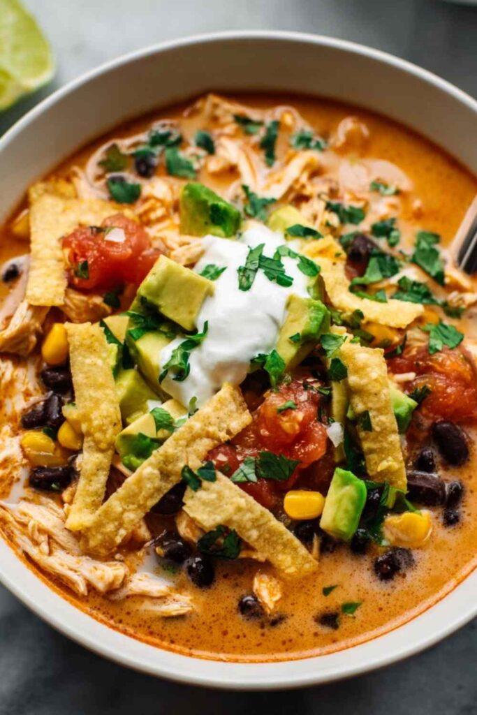 chicken taco soup in bowl with toppings