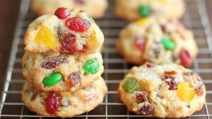 Easy Christmas Fruitcake Cookies with red and green candied cherries on cooling rack