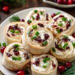 Savory Christmas Cranberry Roll Ups sliced and arranged on white platter