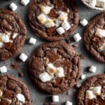 Hot chocolate cookies with marshmallows and chocolate chunks on cooling rack