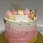 Pink butterfly birthday cake with ombre buttercream and gold decorations