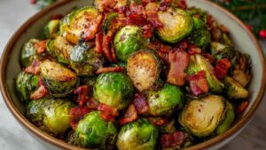Close-up of roasted Brussels sprouts glistening with olive oil and topped with crispy bacon bits, served in a rustic holiday bowl.