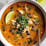 Easy chicken poblano soup in white bowl garnished with cilantro