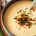 High-protein cream of potato soup in white bowl garnished with chives