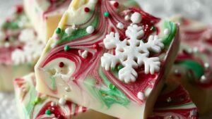 White chocolate Christmas bark with red and green swirls and holiday sprinkles