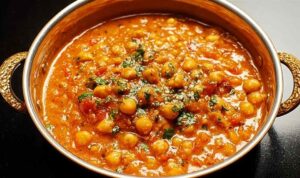 CHICKPEA CURRY Chickpea curry in bowl with rice and cilantro garnish