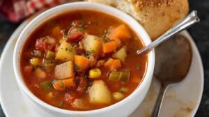 Easy Slow Cooker Vegetable Soup Crock pot filled with vegetable soup.