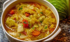 Cabbage Soup Diet Recipe Cabbage soup diet recipe in white bowl with colorful bell peppers and fresh herbs