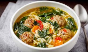 Italian Wedding Soup Bowl of Italian wedding soup with beef meatballs, vegetables, and orzo pasta garnished with parmesan