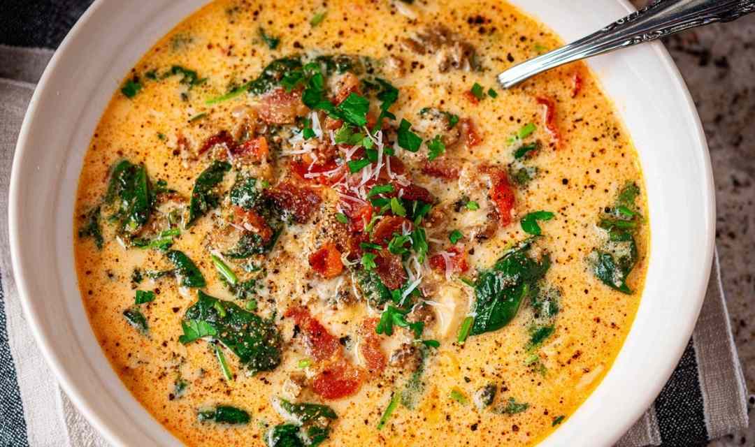 Keto Tuscan soup in bowl with Italian sausage and parmesan garnish