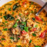 Keto Tuscan soup in bowl with Italian sausage and parmesan garnish