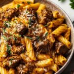 reamy garlic beef pasta with Parmesan cheese and fresh herbs