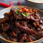 crispy chilli beef with peppers and onions in sweet spicy sauce