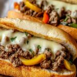 ground beef Philly cheesesteaks with melted provolone cheese and peppers