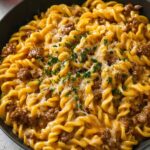 one-pot creamy beef and garlic butter pasta in skillet with melted cheese
