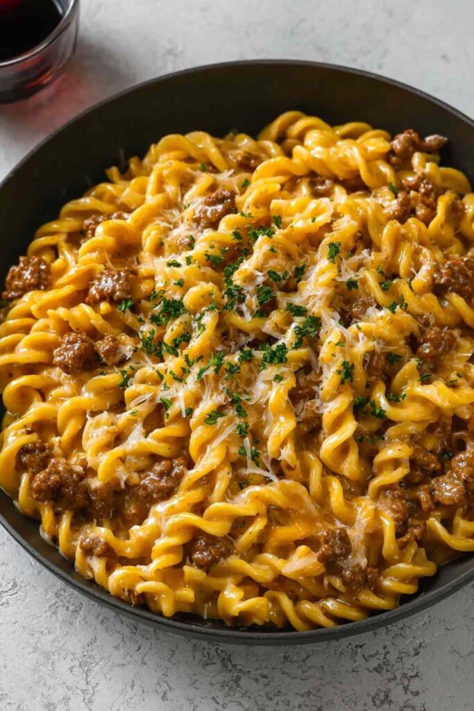 one-pot creamy beef and garlic butter pasta in skillet with melted cheese