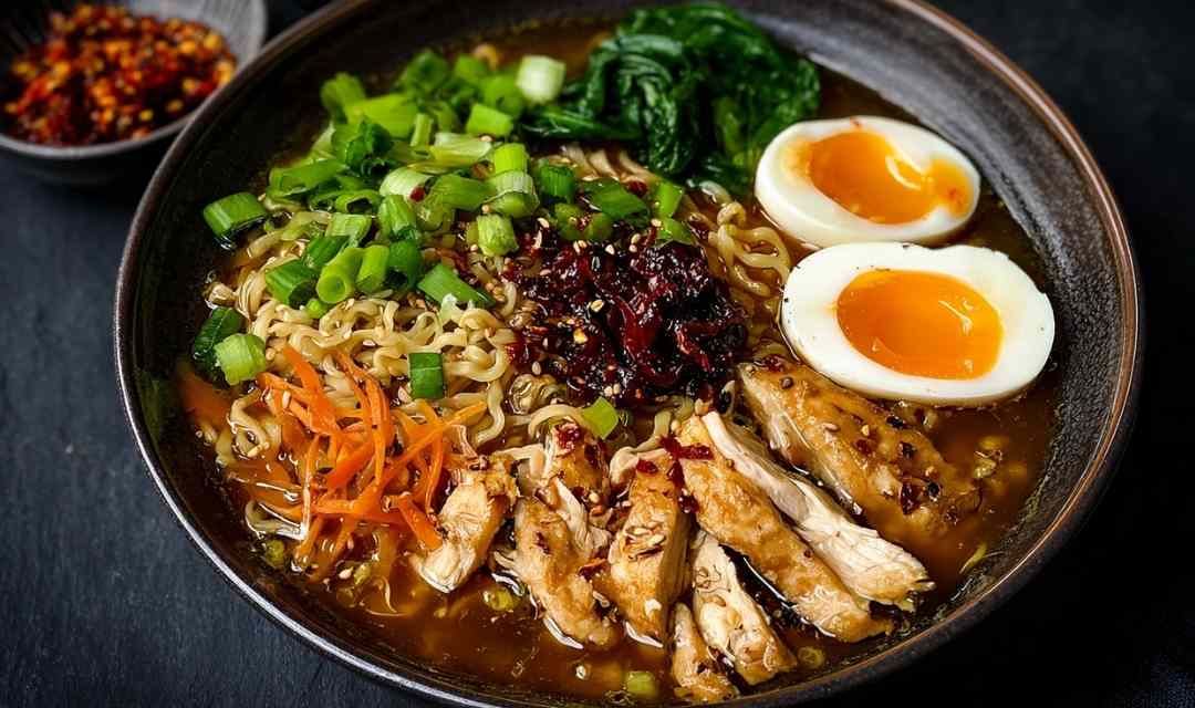 Bowl of vegan vegetable noodle soup with angel hair noodles and fresh parsley garnish