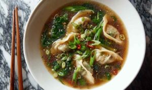 Bowl of Asian Potsticker Soup with ginger broth and dumplings