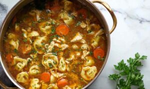 Chicken tortellini soup in bowl with cheese tortellini and vegetables
