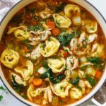 Chicken tortellini soup in bowl with cheese tortellini and vegetables