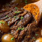 French Onion Pot Roast with caramelized onions in Dutch oven