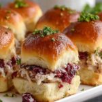 Easy Turkey Cranberry Sliders on baking dish with melted cheese