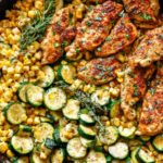 Garlic Butter Chicken with Zucchini and Corn in a cast-iron skillet
