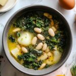 Greek Healing Soup in white bowl with chickpeas vegetables and fresh parsley garnish