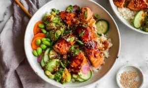 Honey sriracha salmon bowls with rice, avocado, cucumber and edamame