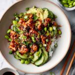 Honey sriracha salmon bowls with rice, avocado, cucumber and edamame