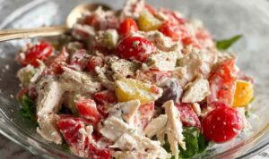 Italian Grinder Chicken Salad served in a bowl with crackers and fresh vegetables
