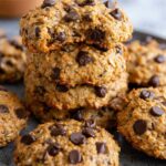 Stack of oatmeal peanut butter protein cookies with chocolate chips on white plate