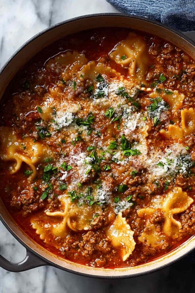One pot lasagna soup with broken noodles ricotta and melted mozzarella cheese in bowl