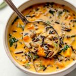 Pumpkin Wild Rice Soup in bowl garnished with toasted pumpkin seeds