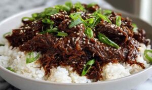 Slow Cooker Korean Beef served over white rice with green onions