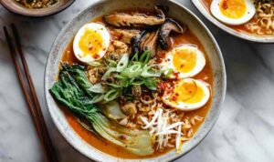 Spicy miso ramen in bowl with soft boiled egg and green onions