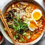 Spicy miso ramen in bowl with soft boiled egg and green onions